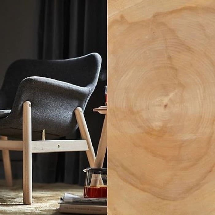 Close-up of smooth light wood grain with a wooden chair.