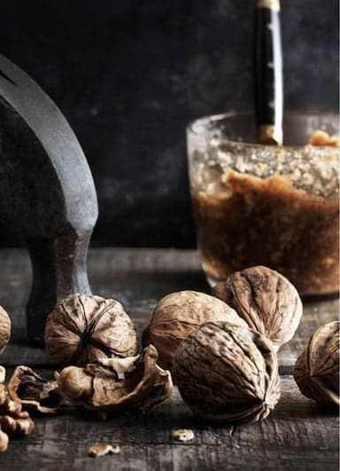 Close-up of whole and cracked walnuts.