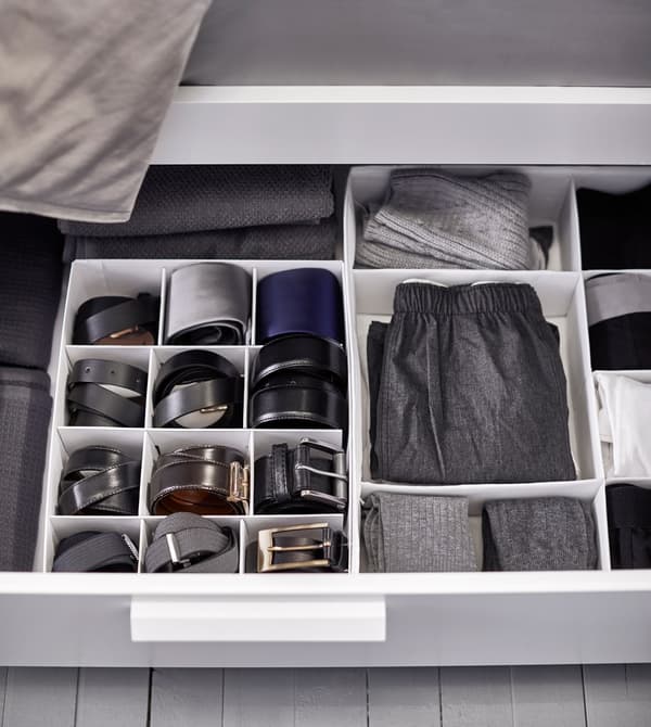Clothing and belts are kept tidy with interior organisers inside a drawer under the bed.