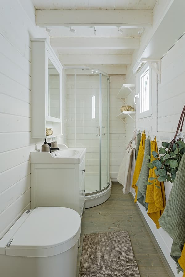 Compact bathroom with shower, sink, and modern decor