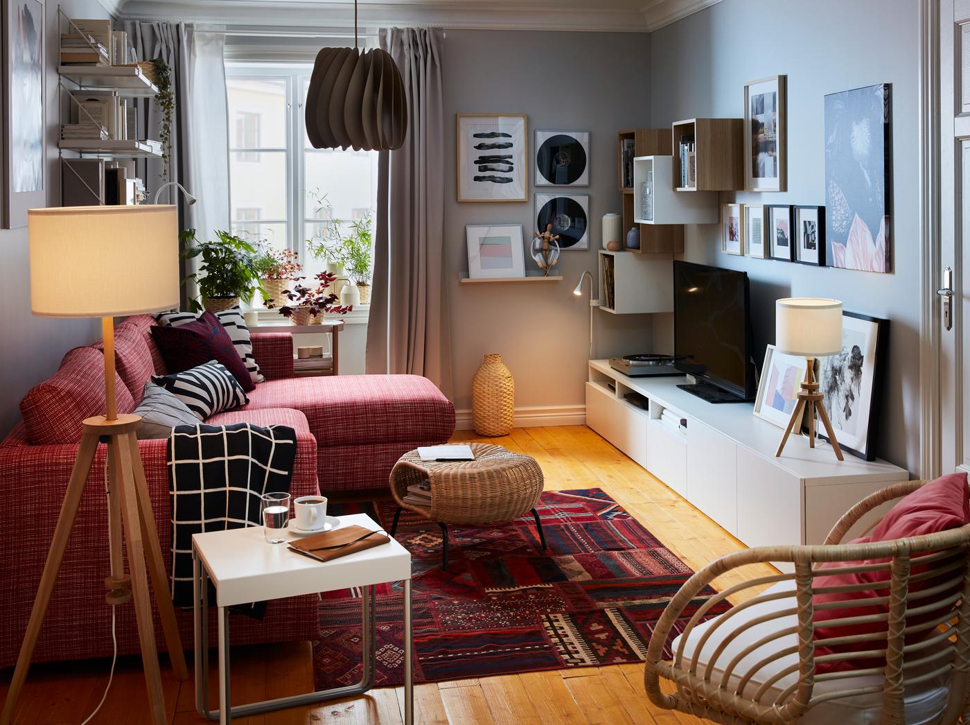 Compact living room with a sofa-bed with chaise longue on one side; sideboard, storage, TV, stereo and art on the other.