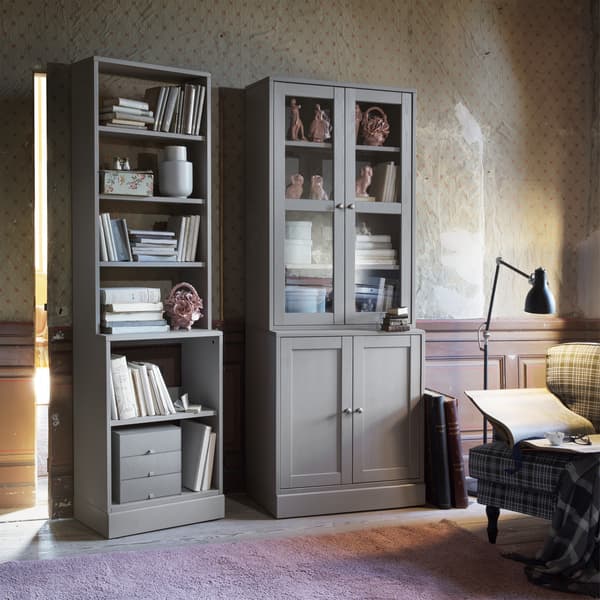 Cream living room with two grey HAVSTA cabinets displaying books.