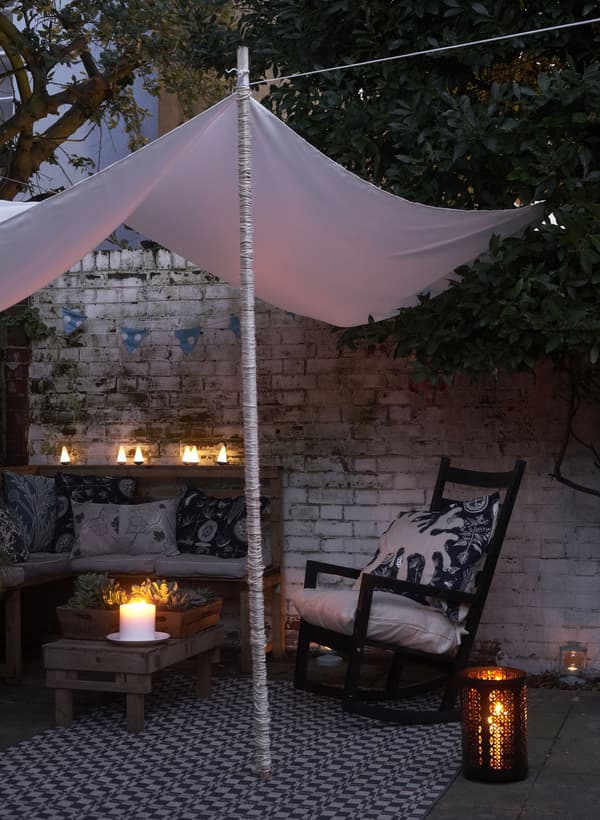 Create a cosy corner with a canopy and lanterns 
