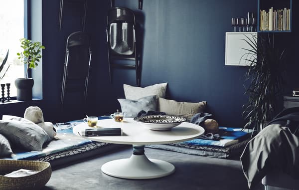 Create a low-level dining and entertaining space with some mattress and cushions on the floor and a DIY low-level table hack.