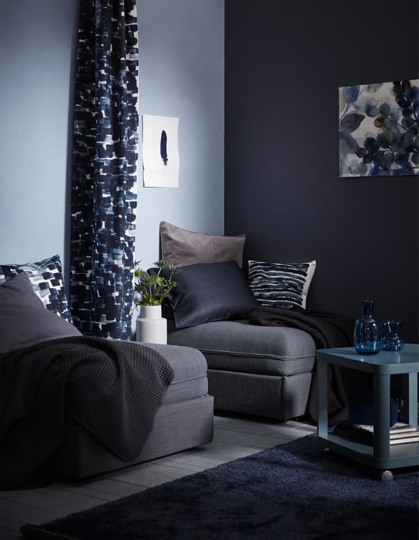 Create a room divider with a piece of fabric! IKEA has lots of different fabrics that can be used as a flowing room divider, such as IKEA STOCKHOLM in a blue checked pattern. Just attach the fabric to a curtain rod rail hanging from the ceiling.