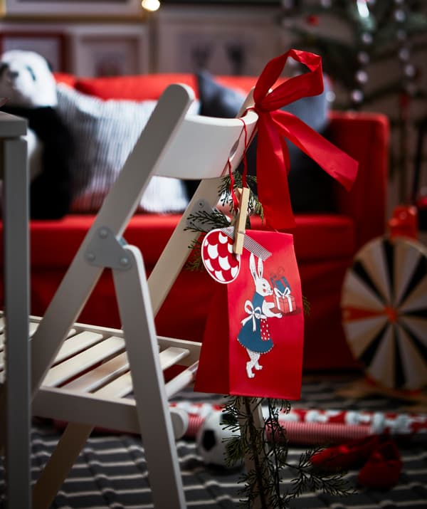 Create an extra festive holiday atmosphere with IKEA VINTER gift bags and tags.