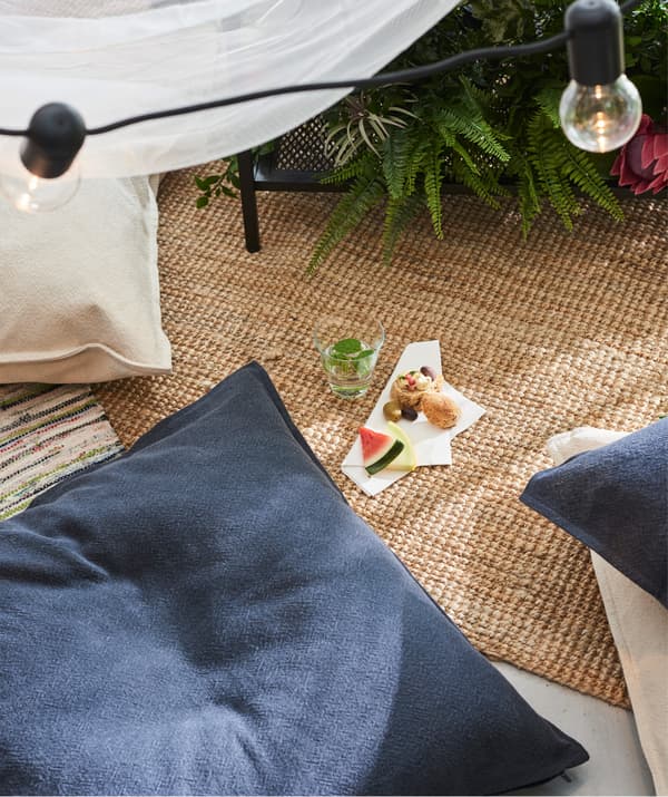 Créez une ambiance cosy et mangez par terre ! Parsemez le sol de quelques coussins confortables habillés de jolies housses, comme la housse IKEA JOFRID en bleu foncé et gris!