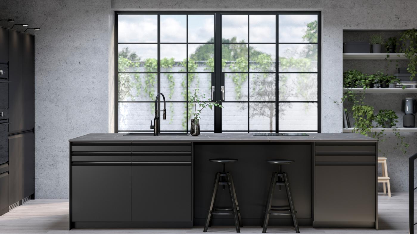 Cuisine avec façades anthracite UPPLÖV, tabourets de bar DALFRED noirs et plaque de cuisson à induction FÖRDELAKTIG avec hotte intégrée.
