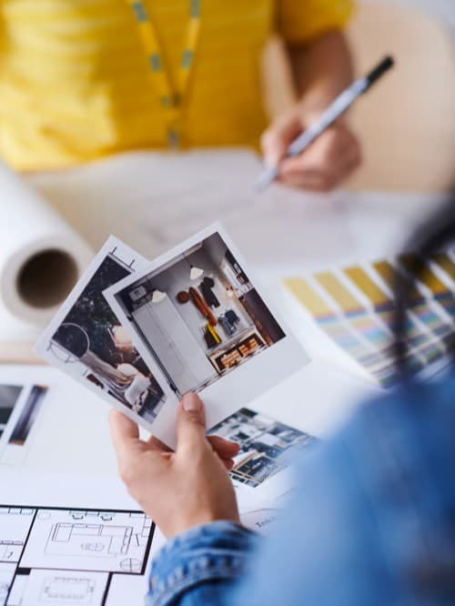 Customer with IKEA worker looking into pictures