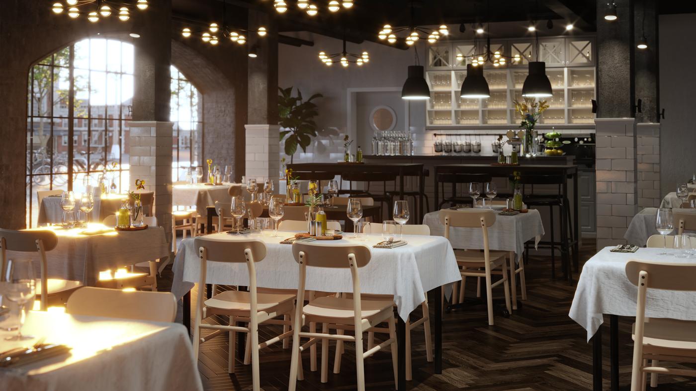 Dans un spacieux restaurant, plusieurs tables TOMMARYD joliment dressées avec nappes blanches, verres transparents et fleurs.