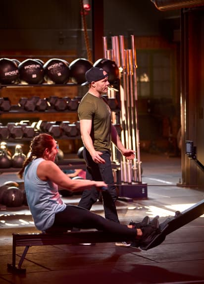 Deux membres CrossFit en train de s'entraîner dans le gym.
