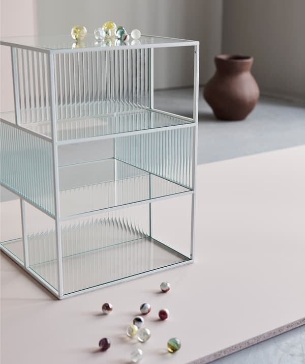 Die dünnen Linien und die Glaspaneele von SAMMANHANG Objektpräsenter weiss/Glas bilden die Bühne für alles, was du in ihm platzierst.