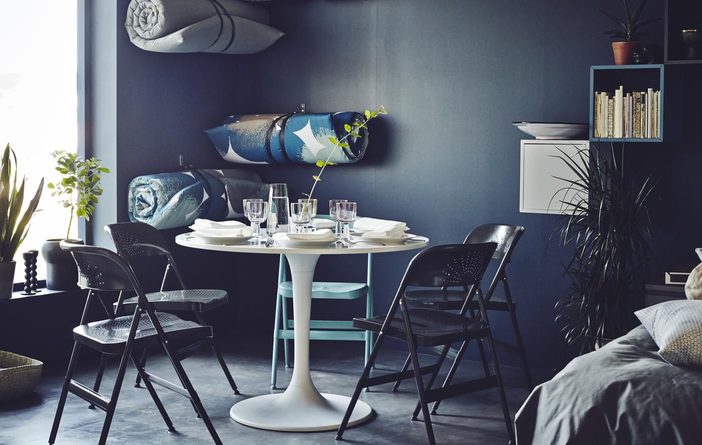 Dining areas needn’t be formal and static. With some fold away chairs, an adjustable table and soft, roll-up mattress close at hand (stored on the wall) it’s easy to create a dining area to suit you.