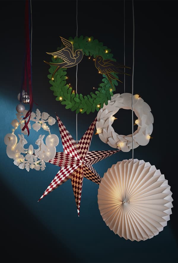 Festive paper decorations and lanterns hanging against a dark blue backdrop.