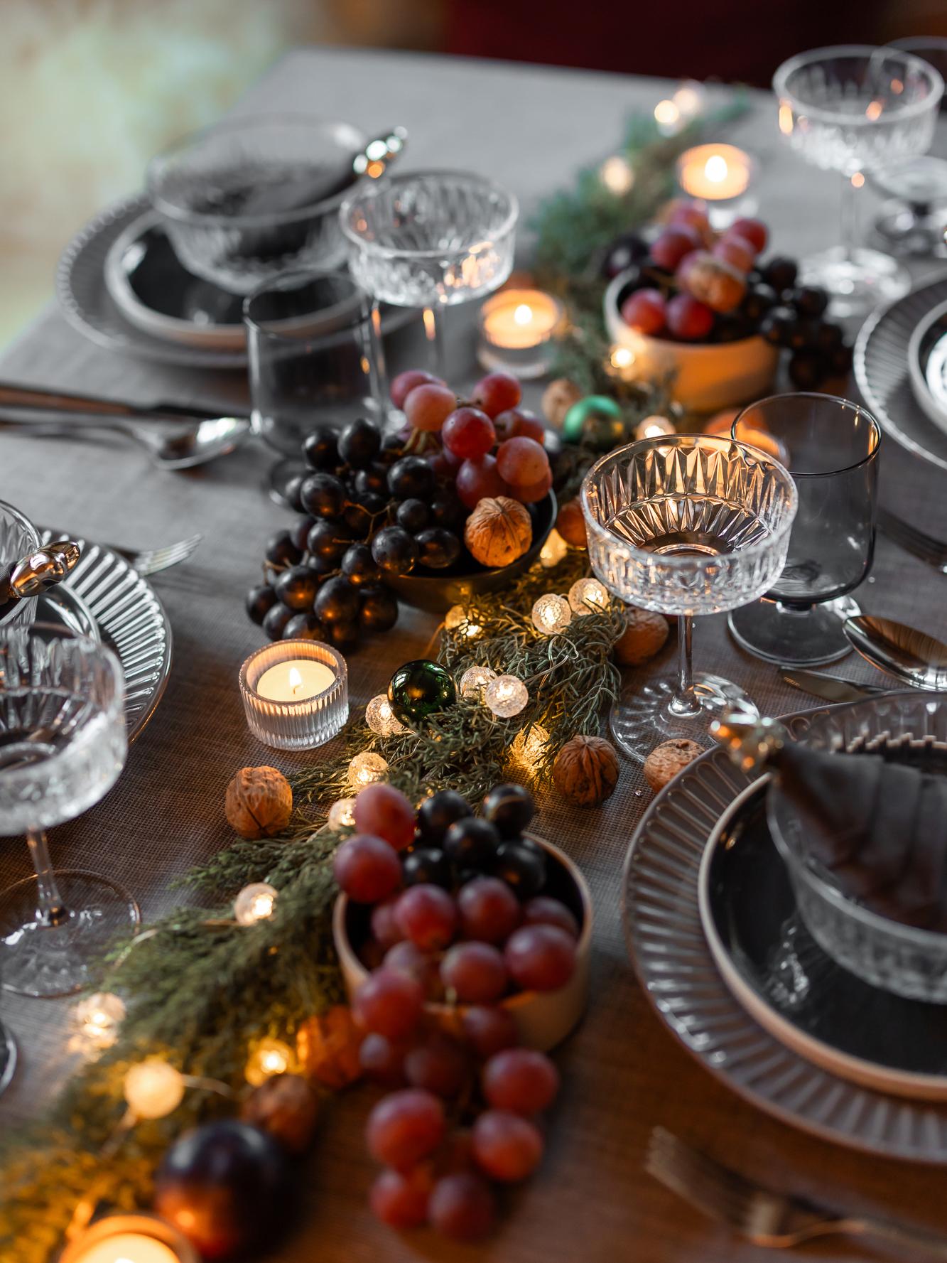 Festively decorated table Glasses, plates and fruit