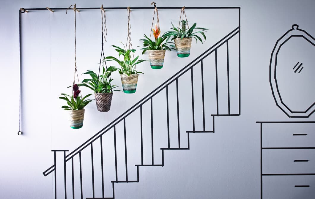 Five hanging baskets clustered together along the stairway is a great way to bring greenery into your home.
