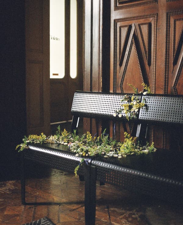 Flowers draped across two black metal chairs.