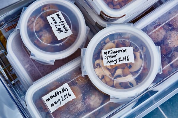Food is stored in the freezer in lots of plastic containers marked with the date and contents.