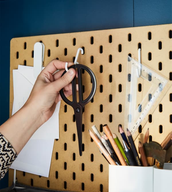 For home office organisation, custom is key. SKÅDIS pegboard in coated fibreboard from IKEA comes in different sizes and has lots of accessories like white-coated steel hooks to hang scissors and other desk supplies.