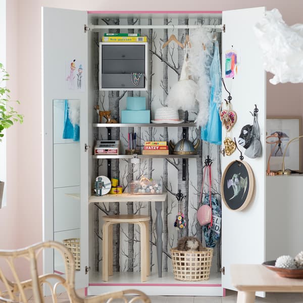 For secret storage ideas in the living room, turn an old wardrobe into a space for toys to get stored away once playtime’s over. IKEA has lots of affordable wardrobes like PAX in tanem white with two white doors.
