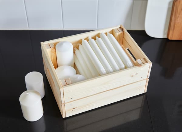 For storage above kitchen cabinets, you can use boxes from IKEA like KNAGGLIG in untreated solid pine. They’re easy to grab, lift and take down because of their built-in handles.
