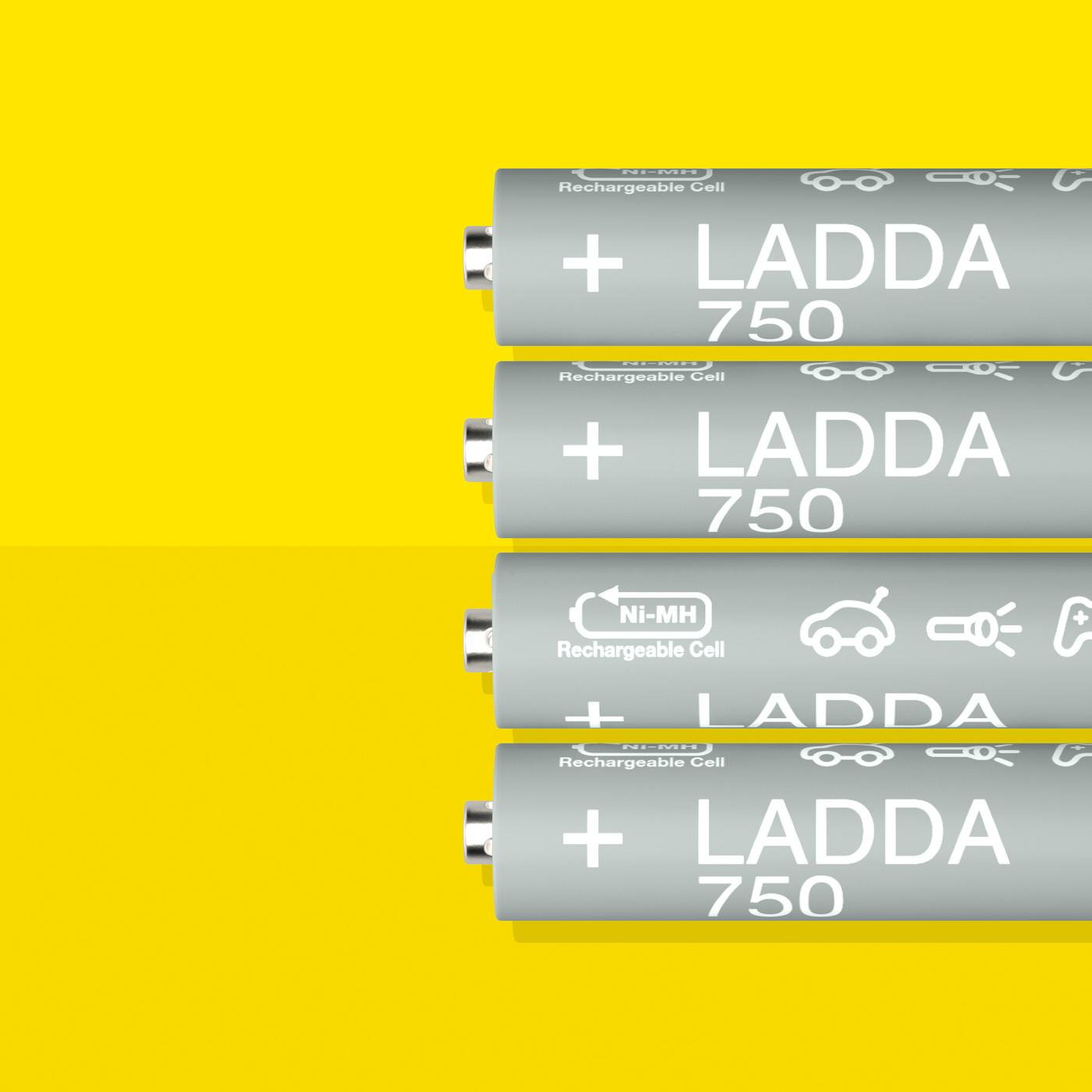 Four LADDA rechargeable batteries, HR03 AAA with a battery capacity of 750 mAh, lie in a row on a yellow surface.