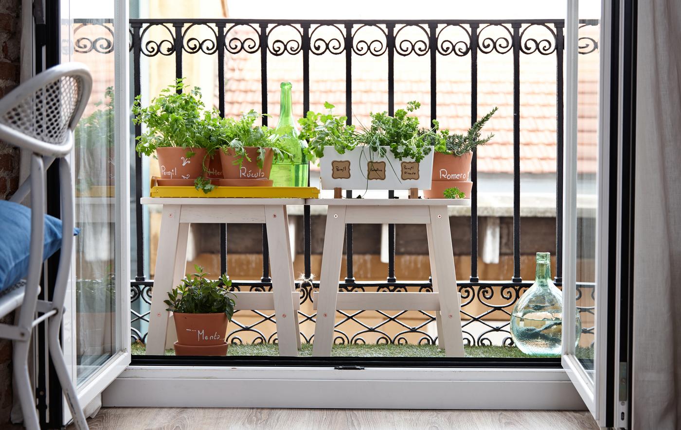 Furnish a tiny balcony with plants to extend living space.