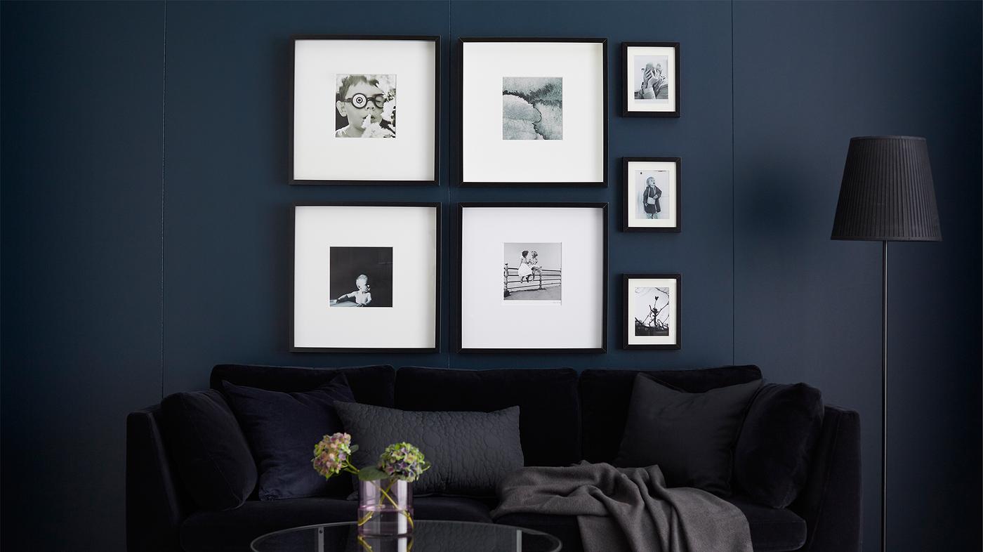 Galerie murale avec cadres contenant des photos en noir et blanc.