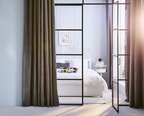 Glass double doors with a bedroom behind.