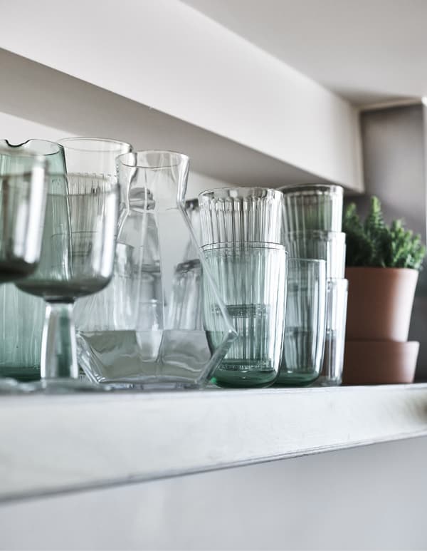 Glasses on a kitchen shelf.