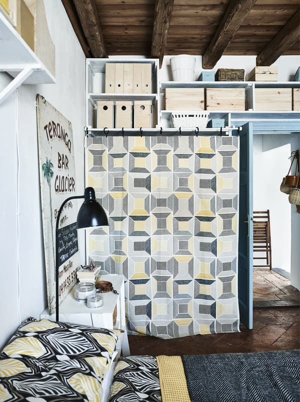 Graphic yellow, black-and-white textiles in a bedroom.