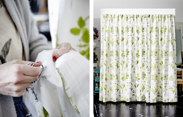 Gros plan d’Agnes en train de manipuler un morceau de tissu. Tissu au motif de feuilles accroché au mur