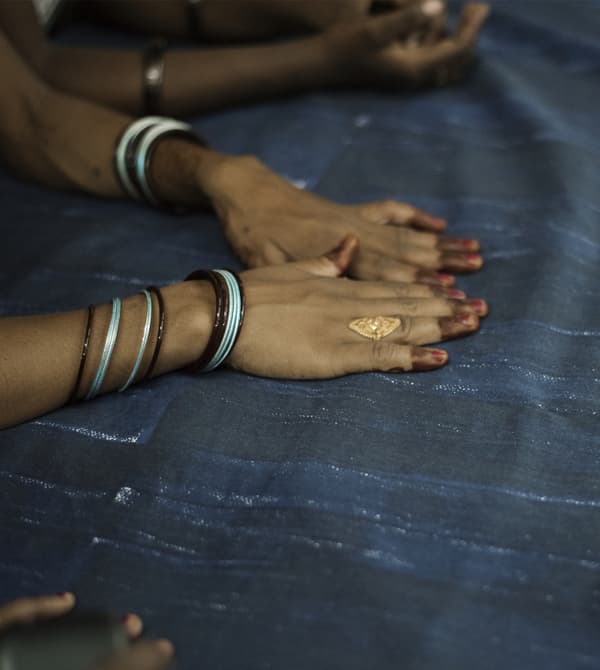 Hands outstretched on a piece of blue fabric.