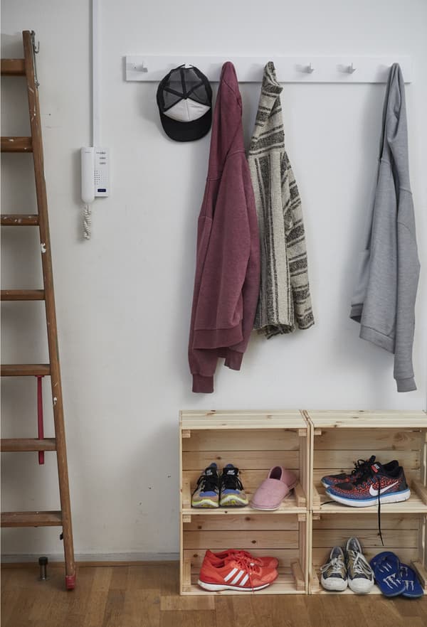 Hanging rack and crates for coats and shoes.
