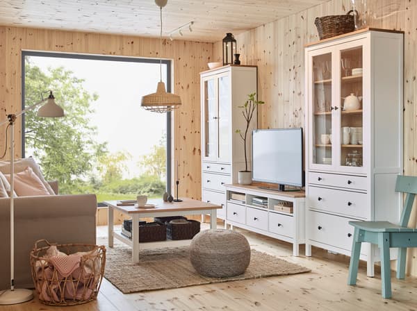 HEMNES pine wood furniture series including tall cabinets with glass doors, coffee table and TV bench crafted from fresh, smooth pinewood.