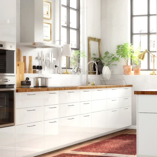 High-gloss white RINGHULT kitchen with rustic details.