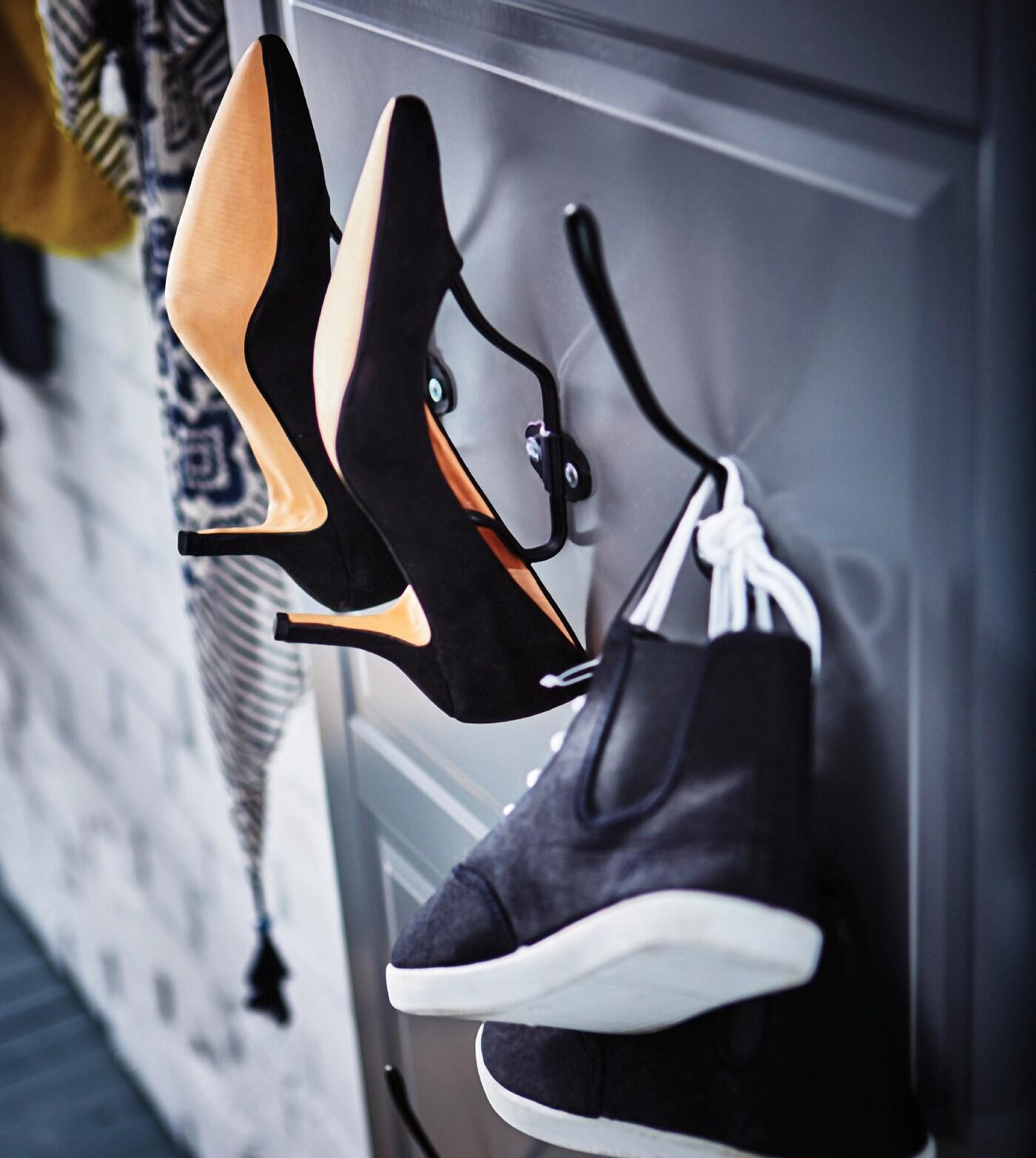Hooks fixed on a kitchen door hung on the wall as a shoe hanger