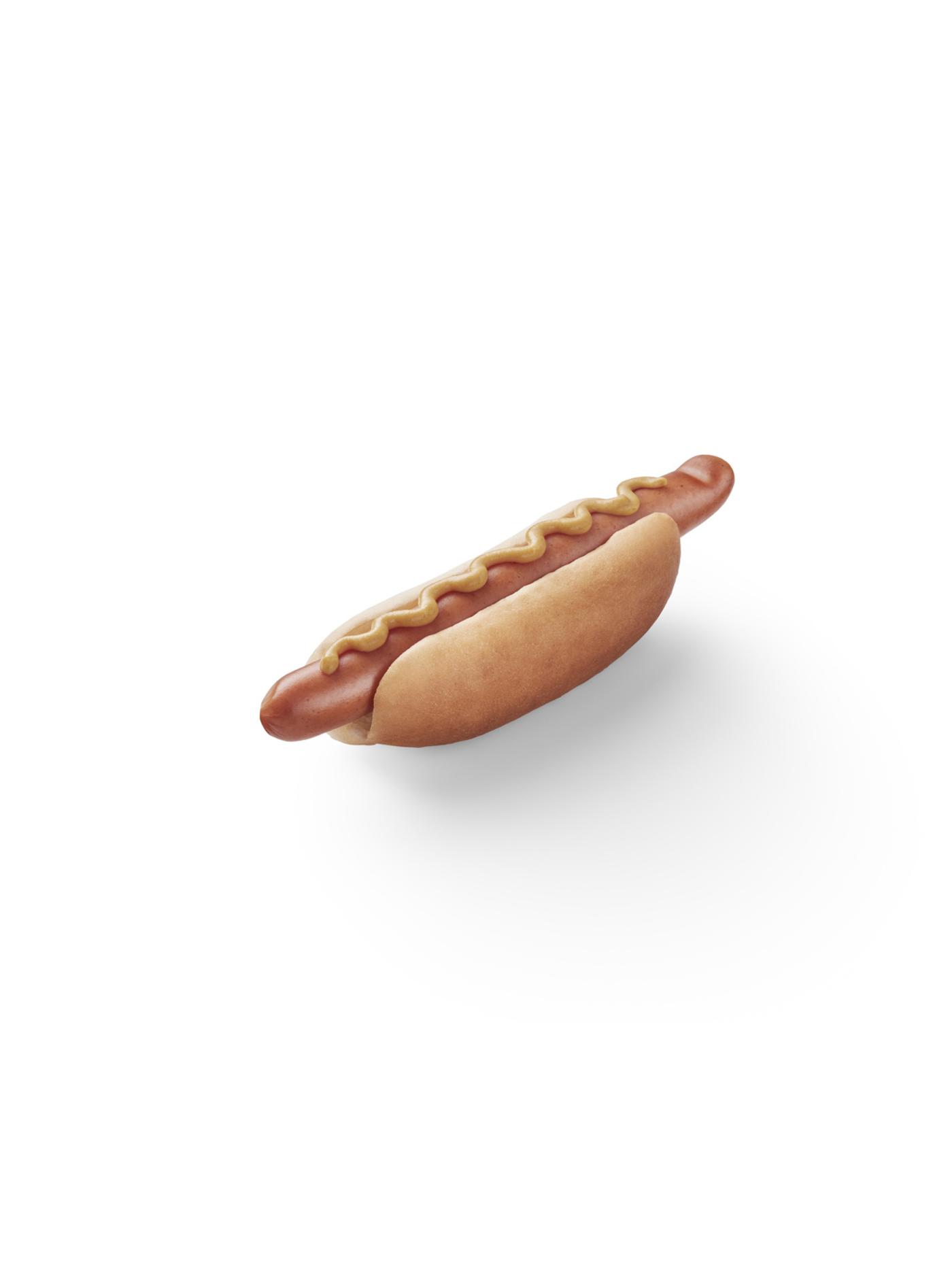 Hot dog in a bun topped with mustard, placed on a white background.