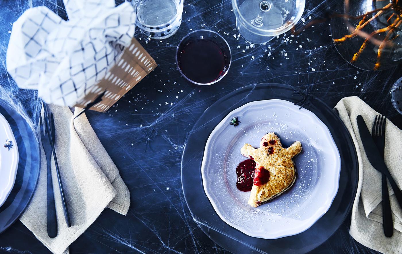 I pancake surgelati IKEA, pronti da scaldare, si possono ritagliare in forme spaventose e servire su un piatto da frutta ARV lilla e con tazze ÖVERSIKT a pois, ideali per i più piccoli