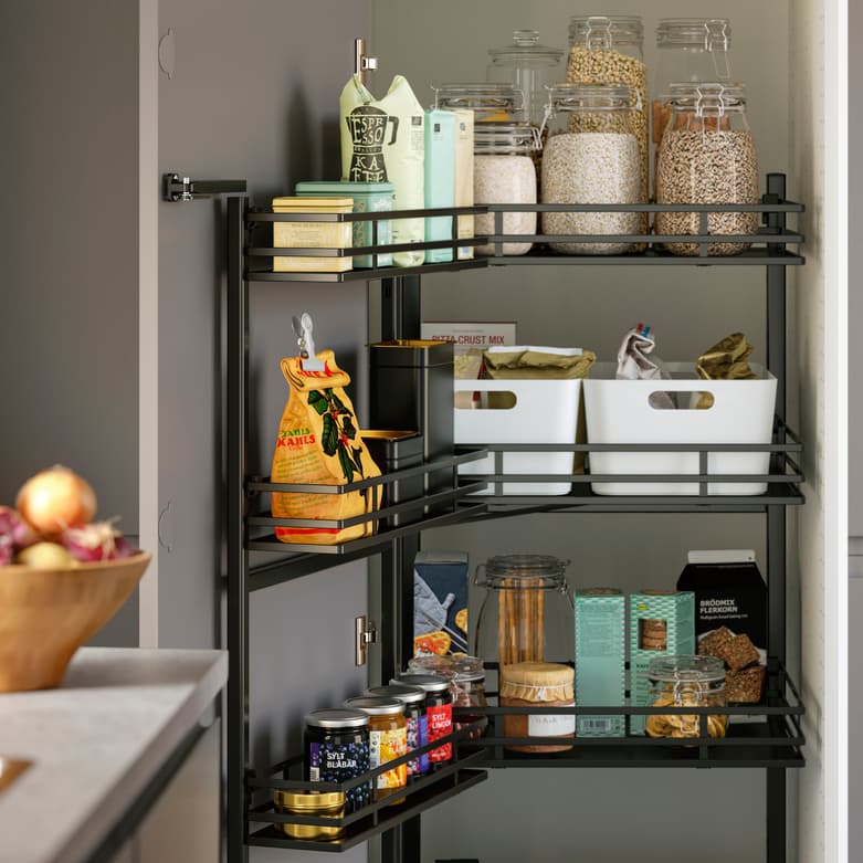 IKEA 365+ food glass containers stacked neatly containing dry foods and beans in a cupboard.