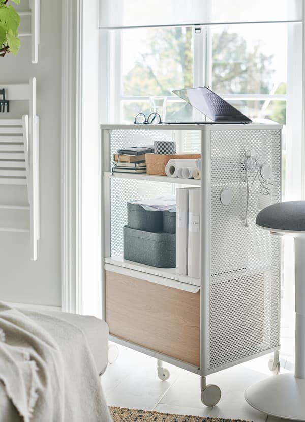 IKEA BEKANT white storage unit comes on castors as a portable storage unit and cabinet. Hang magnets and hooks on its mesh sides for more flexibility.