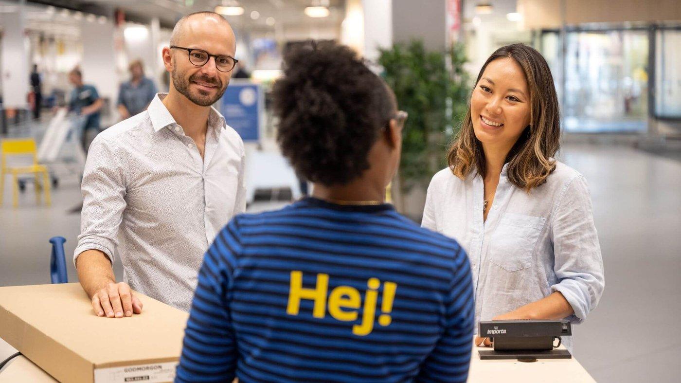 IKEA coworker assisting two customers