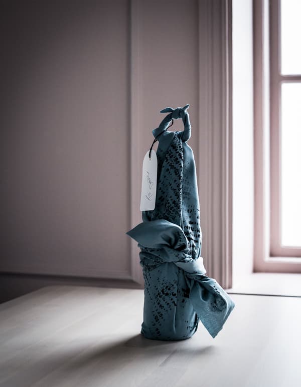 IKEA DITTE fabric makes an affordable gift wrap for bottles. Wrap it and create a cloth handle to carry it to the party. Hang a handwritten tag to make it personal.