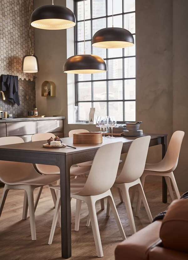 IKEA EKEDALEN dark brown extendable table with six ODGER plastic chairs in beige and white.