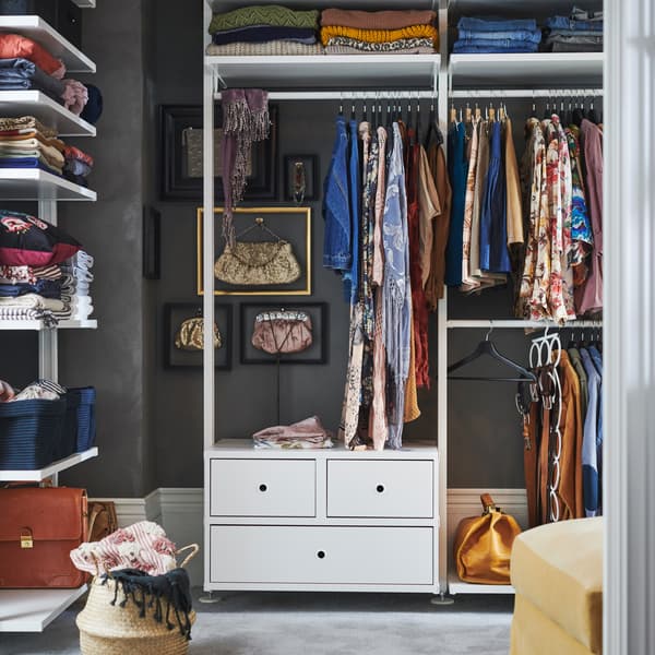 IKEA ELVARLI white open storage wardrobe solution, with clothes rails, closed drawers, and shelves.