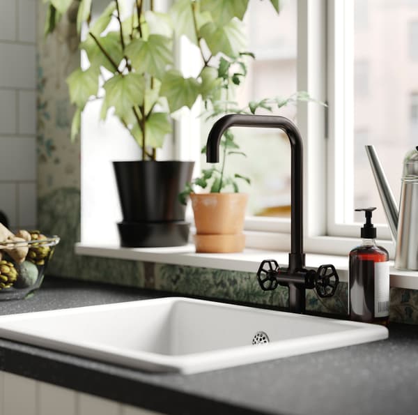 IKEA GAMLESJÖN black kitchen sink tap with spindle-like knobs for a traditional touch.