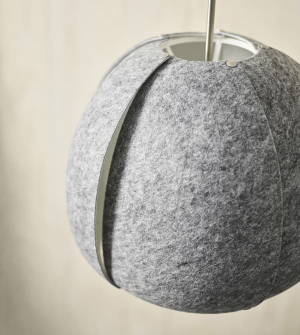 IKEA has a variety of decor to help keep a black and white living room feeling cohesive. Mix in elements that keep the monochrome look but soften it up like felted grey VINTERGATA pendant lamp partially made from reeycled PET-plastic.