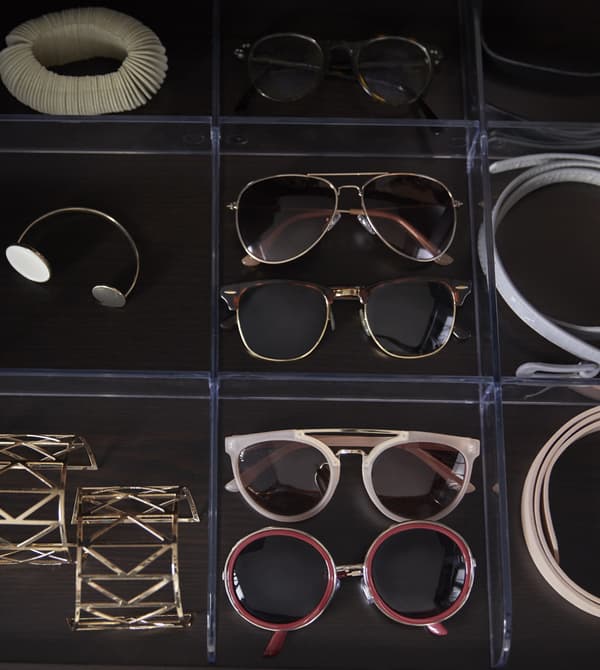 IKEA has a wide range of wardrobe organizers like KOMPEMENT divider for pull-out tray in clear plastic. Its nine compartments word like a grid to keep your accessories in place and easy to access.