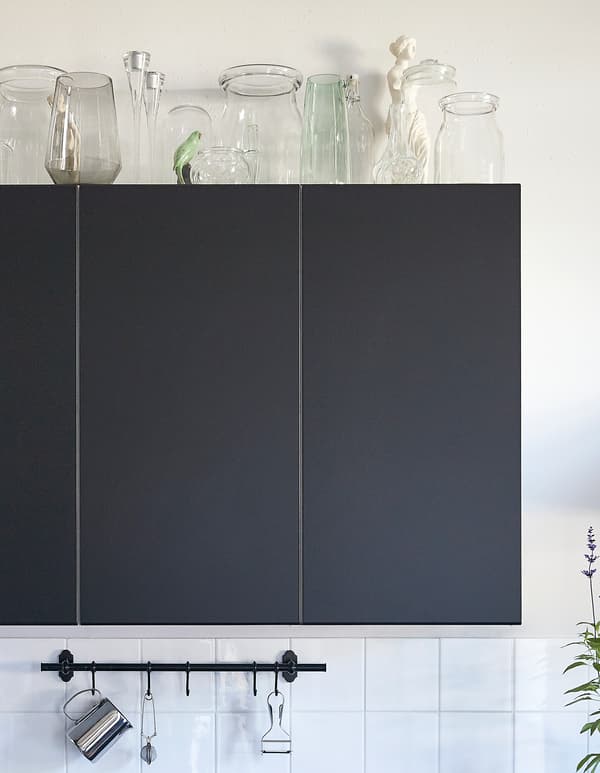IKEA has kitchen decor ideas like turning the space above kitchen cabinets into a display spot. Choose a material and work with it. Glass pieces are one idea like BERÄKNA mouth-blown glass vase mixed with glass candlesticks and glass jars.