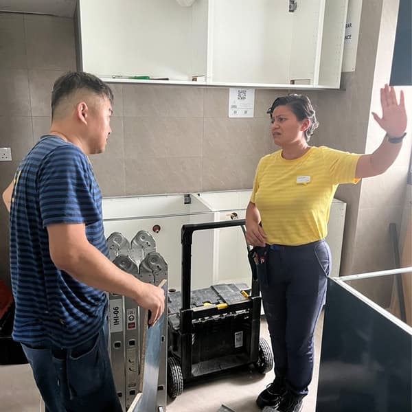 IKEA Kitchen Specialist Shikin having on-site discussions with another IKEA co-worker